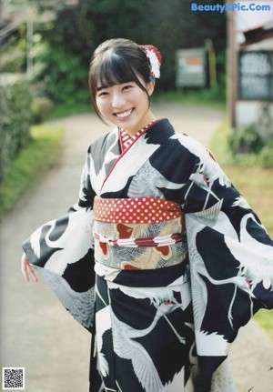 A woman in a kimono is posing for a picture.