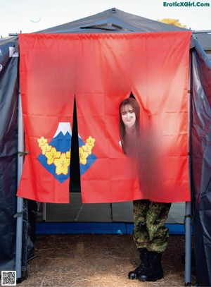 A woman in a military uniform posing for a magazine.