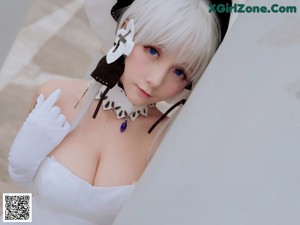 A woman in a white dress sitting on some steps.