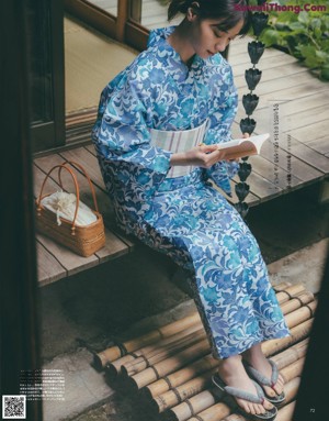 A woman sitting on a bench eating a bowl of food.