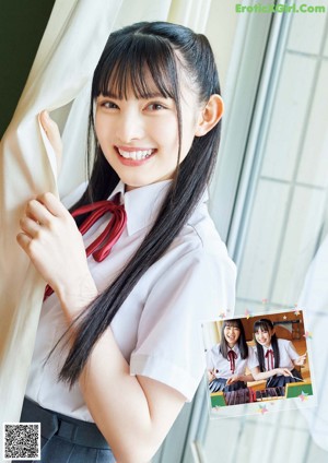 A woman in a school uniform leaning against a railing.