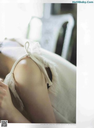 A magazine with a picture of a woman in a white dress.